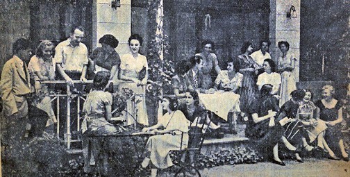 Bryn Mawr Study Group, Summer 1949, gathered on the veranda in front of Reid Hall's dining room; Germaine Brée is standing behind the table in the middle of the group. Photograph retrieved from the New York Herald Tribune, July 14, 1949, n.p. RH archives, scrapbook.