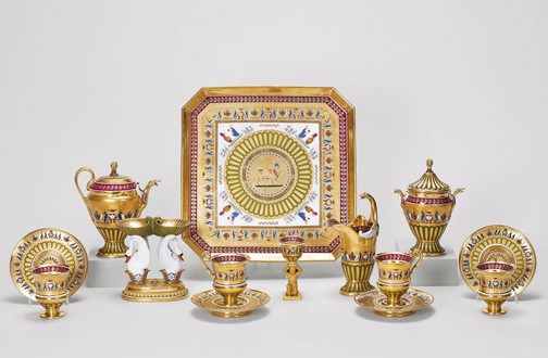 Dagoty and Honoré, Déjeuner, hard paste porcelain, with  burnished gold and crimson and green decoration | Tray 2.3 x 32.0, tea pot 16.8 x 15.6 x 8.0, cream jug 16.8 x 9.6 x 7.0, sugar bowl & cover 17.0 x 12.7 x 7.3, cups 9.5 x 8.7 x 7.2, saucers 2.4 x 13.6, egg cup 10.5 x 4.8, double salt cellar 14.0 x 13.2 x 8.1 cm (whole object) | RCIN 5000000. Acquired by George IV. Recorded in 1826 in the Confectionary, Carlton House: ‘No. 161