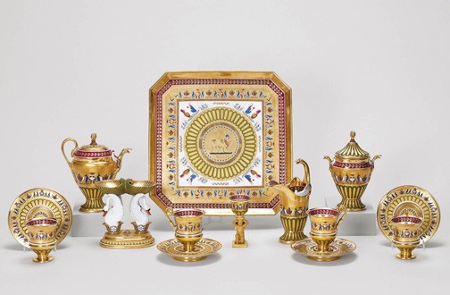 Dagoty and Honoré, Déjeuner, hard paste porcelain, with burnished gold and crimson and green decoration | Tray 2.3 x 32.0, tea pot 16.8 x 15.6 x 8.0, cream jug 16.8 x 9.6 x 7.0, sugar bowl & cover 17.0 x 12.7 x 7.3, cups 9.5 x 8.7 x 7.2, saucers 2.4 x 13.6, egg cup 10.5 x 4.8, double salt cellar 14.0 x 13.2 x 8.1 cm (whole object) | RCIN 5000000. Acquired by George IV. Recorded in 1826 in the Confectionary, Carlton House: No. 161, Royal Collection Trust Dagoty and Honoré, Déjeuner, hard paste porcelain, with burnished gold and crimson and green decoration | Tray 2.3 x 32.0, tea pot 16.8 x 15.6 x 8.0, cream jug 16.8 x 9.6 x 7.0, sugar bowl & cover 17.0 x 12.7 x 7.3, cups 9.5 x 8.7 x 7.2, saucers 2.4 x 13.6, egg cup 10.5 x 4.8, double salt cellar 14.0 x 13.2 x 8.1 cm (whole object) | RCIN 5000000. Acquired by George IV. Recorded in 1826 in the Confectionary, Carlton House: ‘No. 161