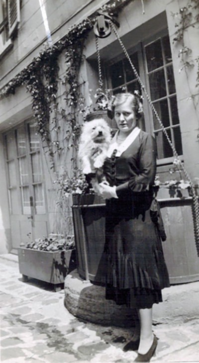 MIss Leet with her dog, Gillie, in Reid Hall's courtyard, Source