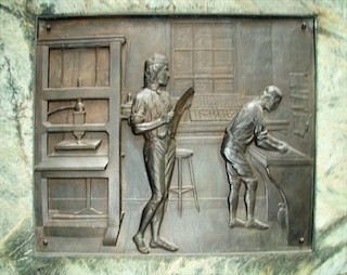 Richard S. Greenough, "Benjamin in Print Shop," front panel of the Benjamin Franklin sculpture, Boston, Mass., 1856-1857, bronze.
