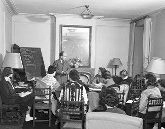 Teaching in one of Reid Hall's salons, 1950s. National Archives Catalog