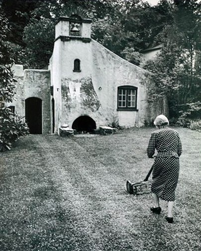 Photo by Richard Stacks of 80-year-old Grace Turnbull mowing the lawn outside her studio. Published in The Sun on June 12, 1960, p. TM15. 