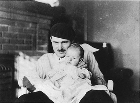 Photograph of Ernest Hemingway holding his son John (“Bumby”), 1924. Kennedy Library. ARC 192694