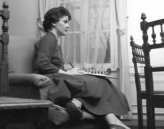 Resident in her bedroom, 1950s. Photograph retrieved from U.S. National Archives & DVIDs.