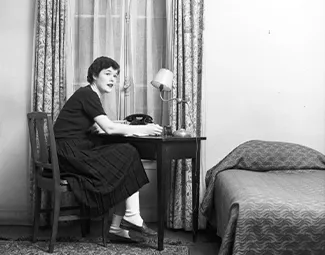 Resident in her bedroom, 1950s. Photograph retrieved from U.S. National Archives & DVIDs.