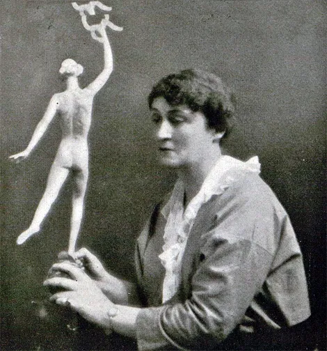 Janet Scudder with her “Feminine  Victory," symbolizing the great work done by women throughout the world during the war. Harper's Bazaar, October 1917, p. 56