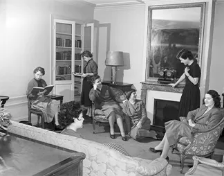 Women in conversation in one of Reid Hall's salons, 1950s. Photograph retrieved from U.S. National Archives & DVIDs.