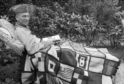 A Lieutenant who had a leg amputation, reading the Red Cross magazine, enjoying the new robe sent by a Red Cross chapter in America (August 1918), American National Red Cross Photograph Collection